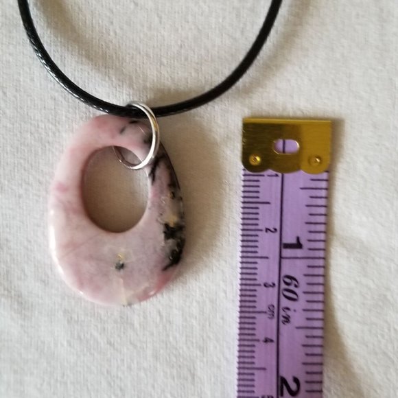 Pink rhodonite gemstone with black veining, natural pendant on a black cord. - Picture 3 of 6